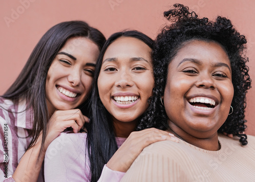 Cheerful multiracial women with different skin color looking in camera - Concept of friendship and happiness