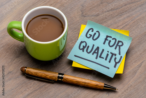 go for quality reminder note with a cup of coffee and pen, business, lifestyle and personal development concept
