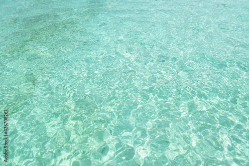 clear sea water surface on sunny day background and texture