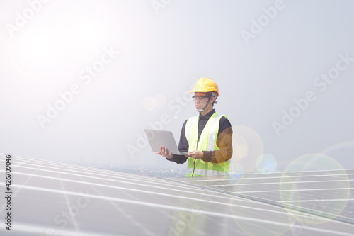 Asian engineer for solar panel inspection roof construction. Engineer worker installing solar panels outdoors