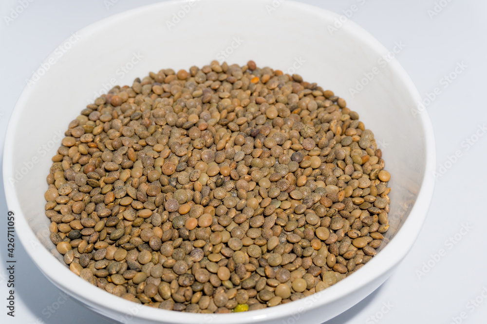 A bowl of red lentils shot in studio settings. In India it is also called black masoor dal. A bowl of red lentils shot in studio settings. In India it is also called black masoor dal.