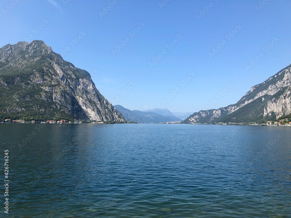 Beautiful landscape, panoramic view of mountain and lake Como in Lecco city, Italy, blue water and clear sky background
