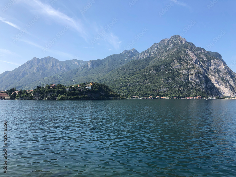 Beautiful landscape, panoramic view of mountain and lake Como in Lecco city, Italy, blue water and clear sky background Beautiful landscape, panoramic view of mountain and lake Como in Lecco city, Italy, blue water and clear sky background