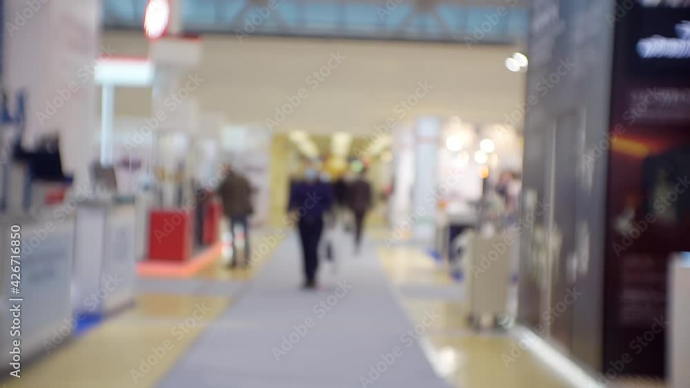 Business theme background. Unrecognizable people in a large and bright business center. Blurry defocused video. Business theme background. Unrecognizable people in a large and bright business center. Blurry defocused video.