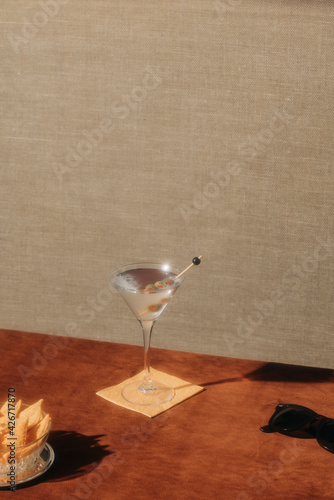 Dry Martini cocktail, with gin and vermut dry; garnished with olive; happy hours at home, homemade drink