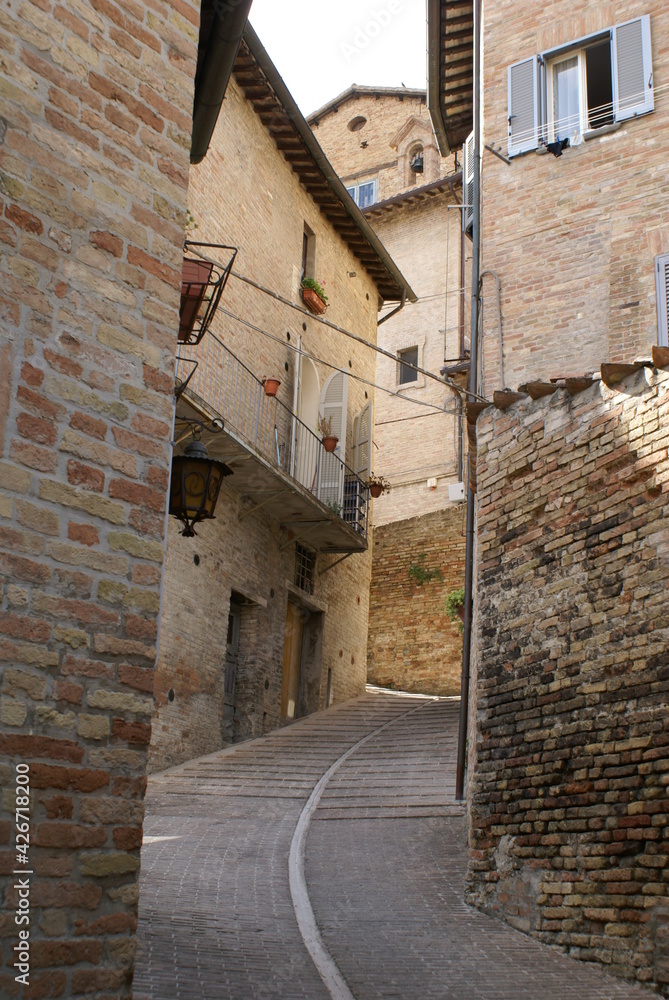 A typical narrow alley in the historical centre of Urbino, Marche (Italy)
