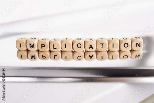 Word implication by wooden cubes photo