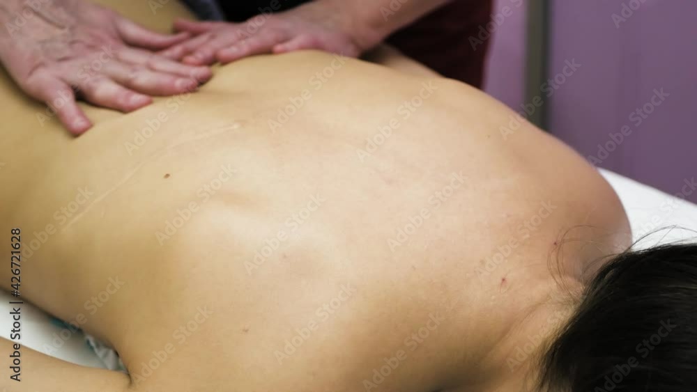masseur doing back massage, massage parlor 4K video masseur doing back massage, massage parlor 4K video