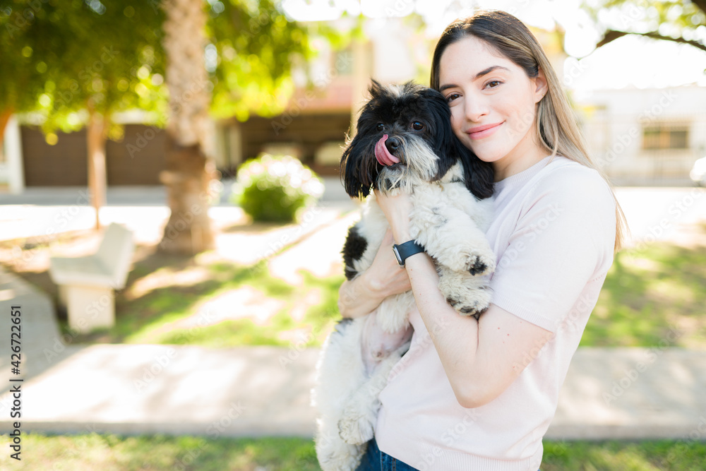 Caucasian woman enjoying time with her dog at the park Caucasian woman enjoying time with her dog at the park
