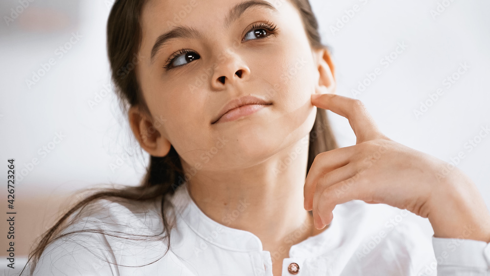 Pensive preteen girl looking away at home. Pensive preteen girl looking away at home.