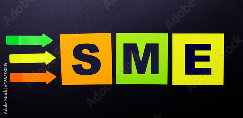 Bright multi-colored paper stickers on a black background with the text SME SUBJECT MATTER EXPERT