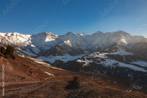Mountain roads of the Tien Shan highlands, at sunset © justoomm