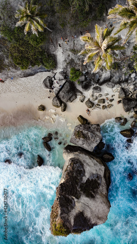 Drone view from above diamond beach bali travel couple black sand beach