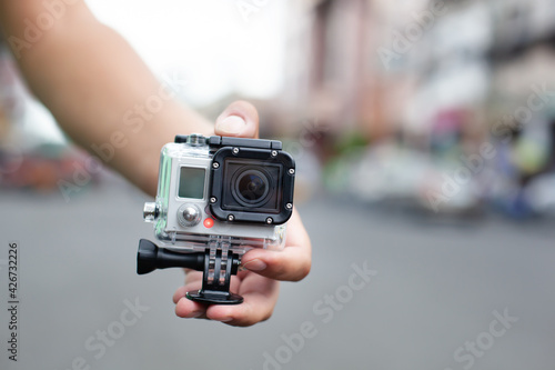 Unrecognizable man holding Action camera. Outdoors