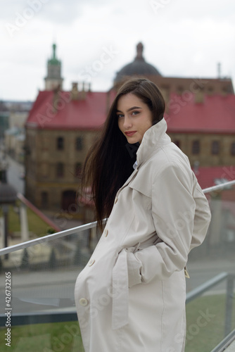 Outdoor portrait of a young beautiful fashionable lady wearing stylish coat . Model looking aside. Female fashion concept. City lifestyle. Close up.