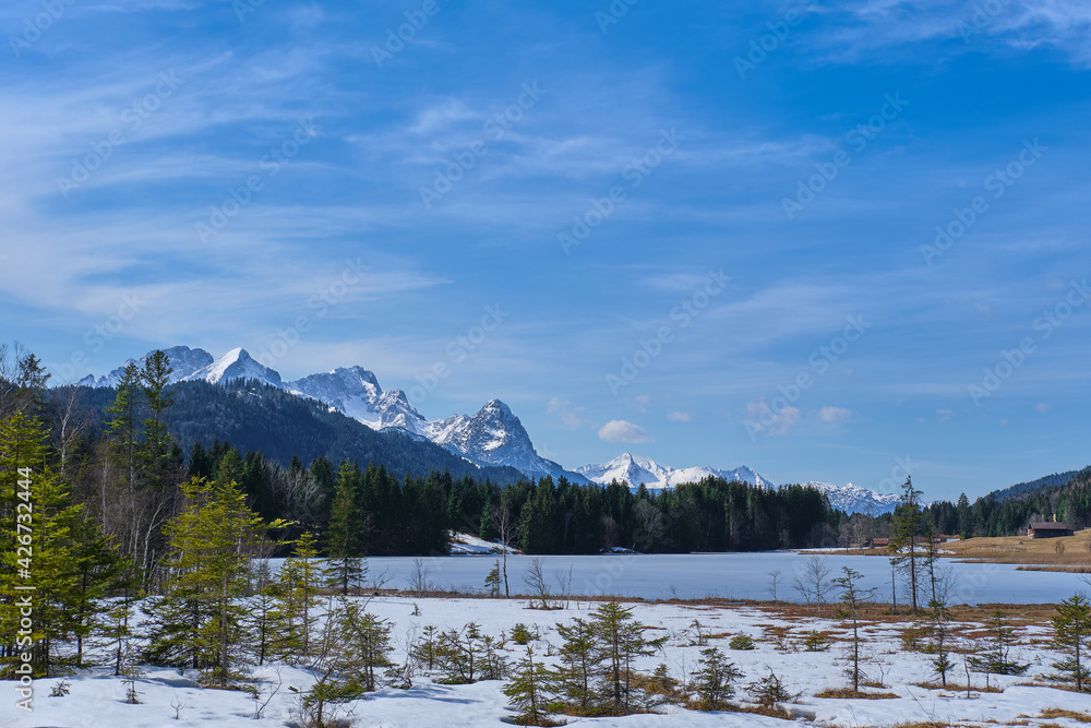 Scenic view of frozen lake Geroldsee and alpine mountains in winter Scenic view of frozen lake Geroldsee and alpine mountains in winter