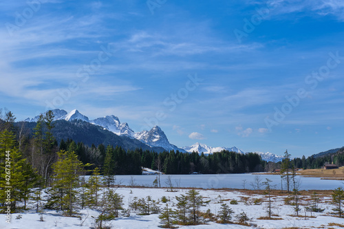 Scenic view of frozen lake Geroldsee and alpine mountains in winter © daktales.photo