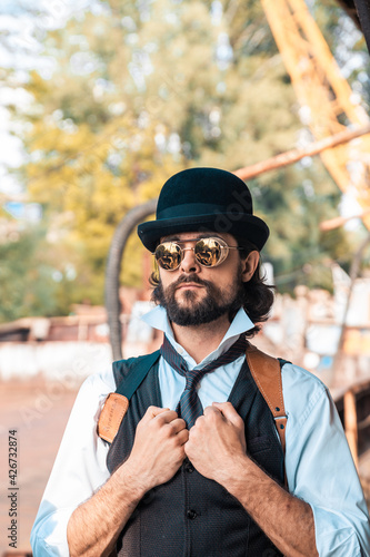 Steampunk. A hero on a river barge surrounded by steel mechanisms. A man with a weapon.