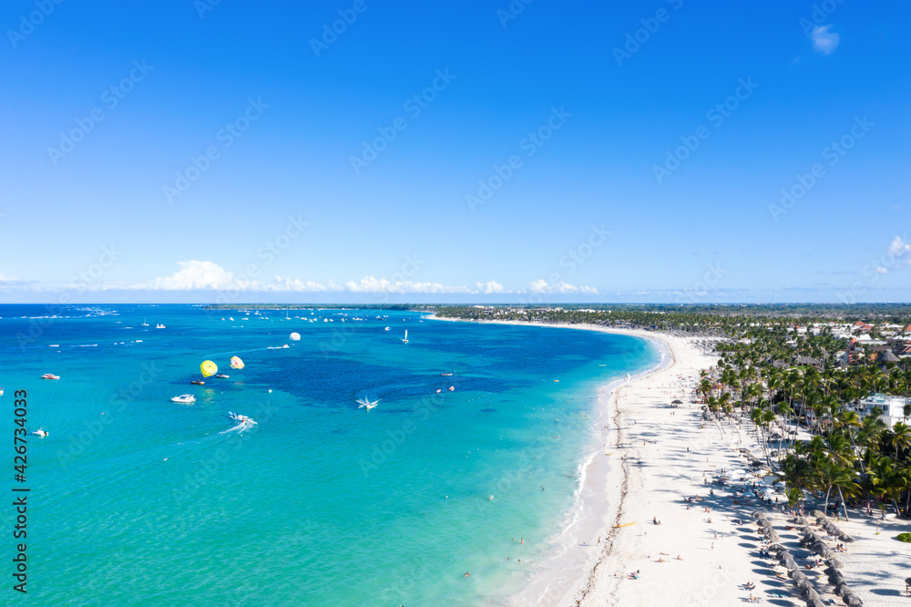 Aerial view from drone on tropical shore with coconut palm trees and turquoise caribbean sea