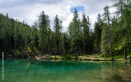 a green lake in the high mountains