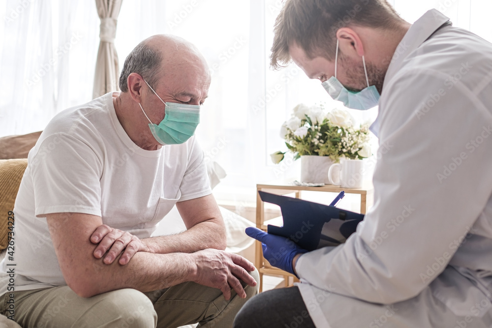 Doctor writing medical prescription to elderly man Doctor writing medical prescription to elderly man