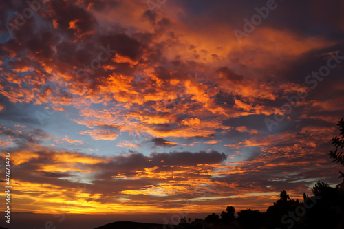magical orange golden clouds at sunrise over the mediterranean sea