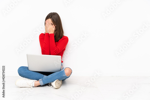 Tenaager girl working with pc isolated on white background with tired and sick expression