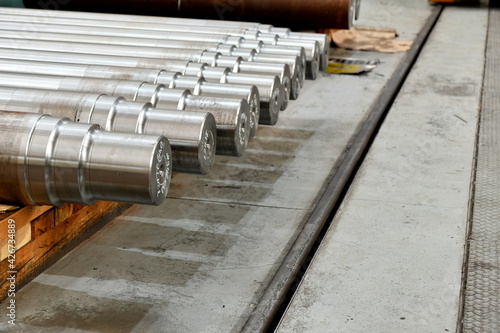 Rolling shafts on racks in a warehouse. © andov