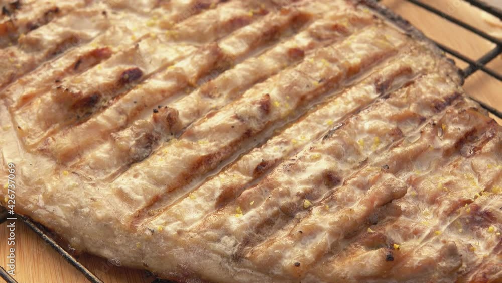 Barbeque grill grid with delicious white Mackerel fish is opening on the background the wooden table Barbeque grill grid with delicious white Mackerel fish is opening on the background the wooden table