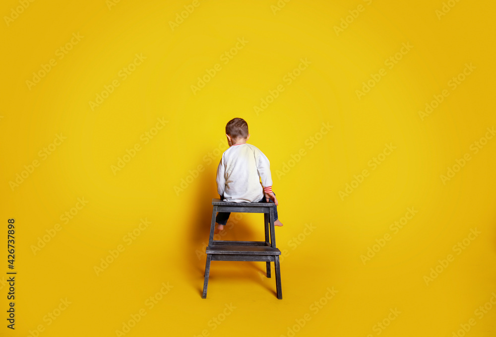 Fototapeta premium child in jeans and a white sweater