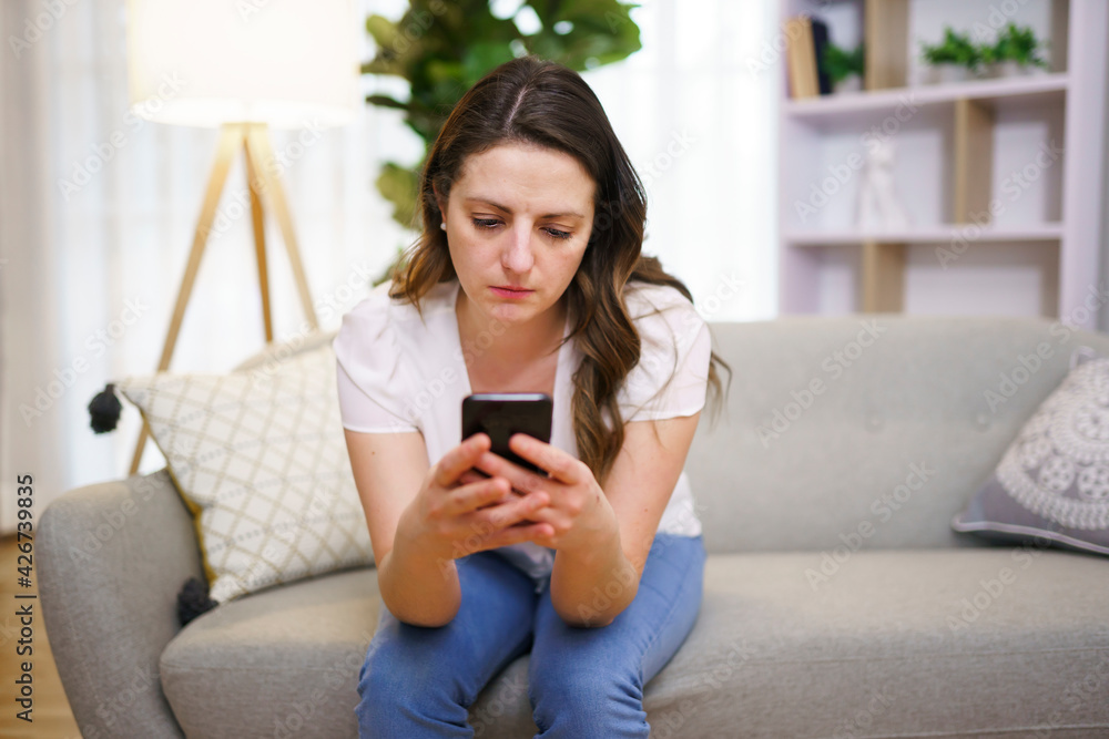 A Young woman sending text message with smartphone A Young woman sending text message with smartphone