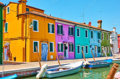 Cozy colorful houses by canal in Burano Island in Venice © Roman Sigaev