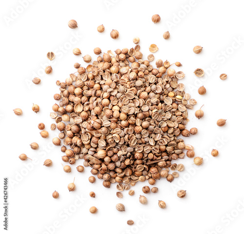 Dry coriander seeds heap on white background, isolated. The view from top
