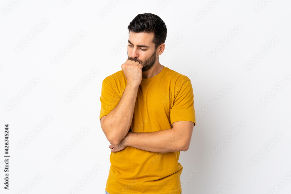 Young handsome man with beard isolated on white background having doubts Young handsome man with beard isolated on white background having doubts