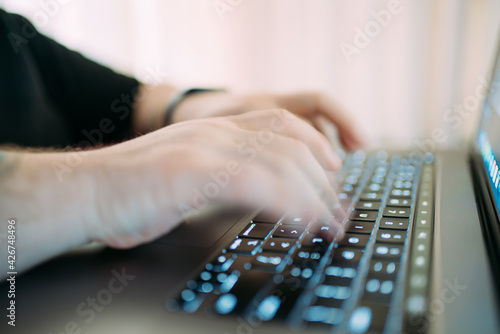 Closeup of man's hand using laptop