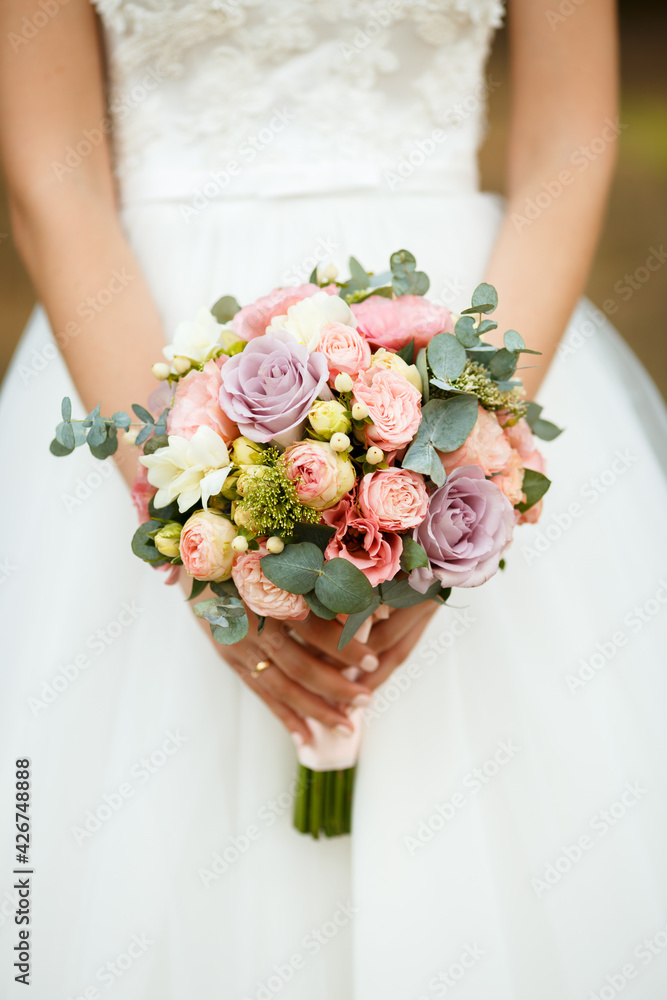 the bride holds the bouquet of flowers in her hand, the wedding floral bouquet the bride holds the bouquet of flowers in her hand, the wedding floral bouquet