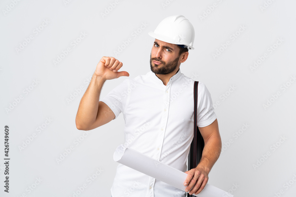 Young architect man with helmet and holding blueprints isolated on white background proud and self-satisfied Young architect man with helmet and holding blueprints isolated on white background proud and self-satisfied