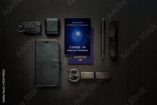 COVID-19 immunity passport on table with technology photo