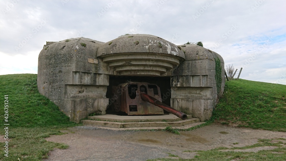 Part of the Atlantic Wall of the German air defenses of the French coast of Normandy. Normandy D-Day Landing Beaches in France on a cold and cloudy winter day. A living memory of the Second World War.