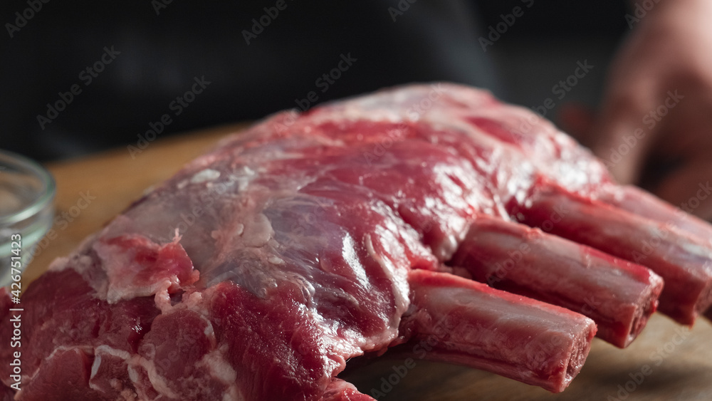 Raw beef ribs on a cutting board