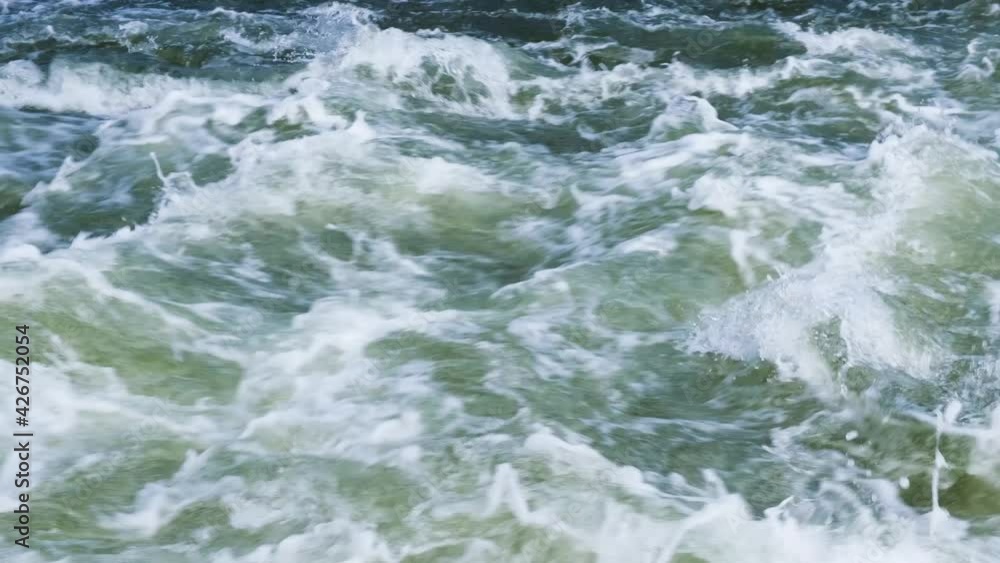 Mountain river water flow in powerful waterfall, video background. Fast stream of water close-up. Mountain river water flow in powerful waterfall, video background. Fast stream of water close-up.