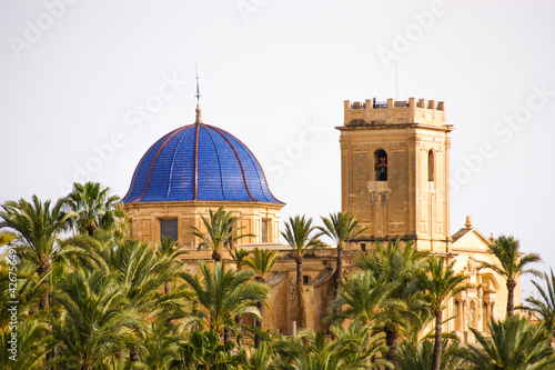Arabic mosque with beautiful blue roof surrounded by a set of palm trees in Elche, Spain. photo