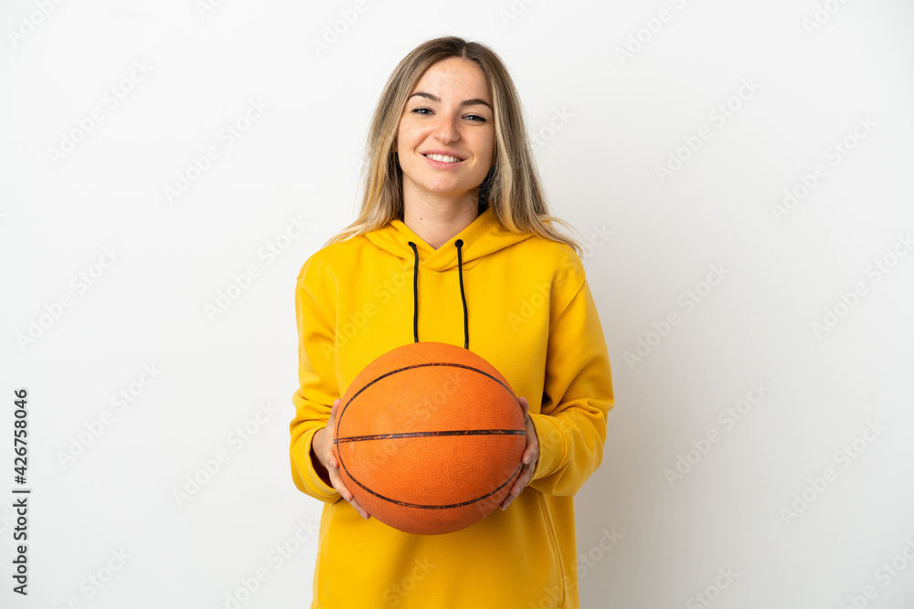 Young woman over isolated white background playing basketball