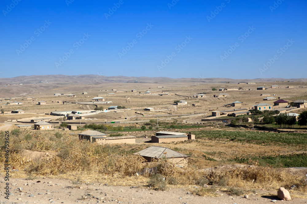 The road in the desert area of Uzbekistan. Buildings