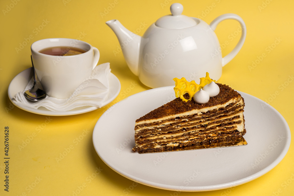 Delicious breakfast with the cake and black tea on yelow background. Top view. Copy space. Delicious breakfast with the cake and black tea on yelow background. Top view. Copy space.