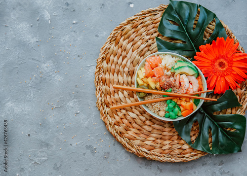 Poke bowl  traditional Hawaiian raw fish salad with rice  avocado  cucumber and radish