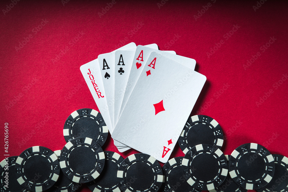 Obraz premium Poker game with five of kind combination. Chips and cards on the red table