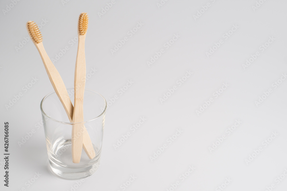 Bamboo toothbrush in glass isolated on white background. Zero-waste, biodegradable bamboo toothbrush