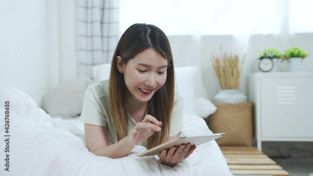 Asian woman using tablet working or making online shopping during quarantine at home Asian woman using tablet working or making online shopping during quarantine at home