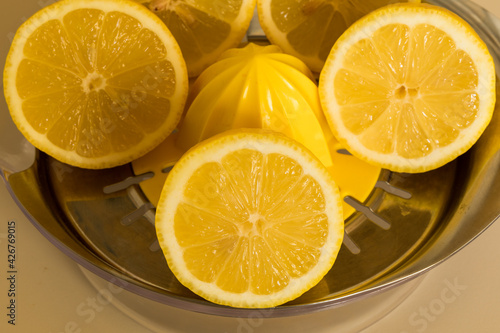 sliced lemons, and a manual juicer